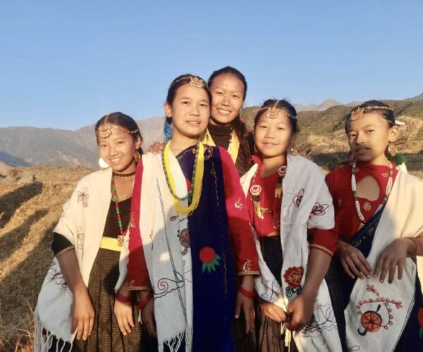 Vital Solutions Work in Nepal, group of women dressed in native garments, outdoors.